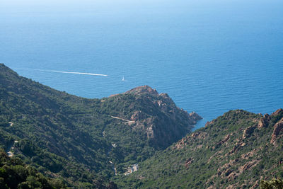 High angle view of sea and mountains against sky