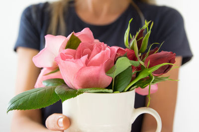Close-up of woman holding pink flower