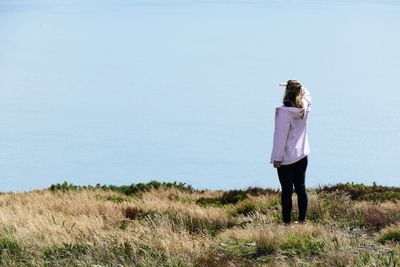 Woman standing against sea