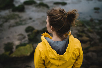 Rear view of woman standing against beach