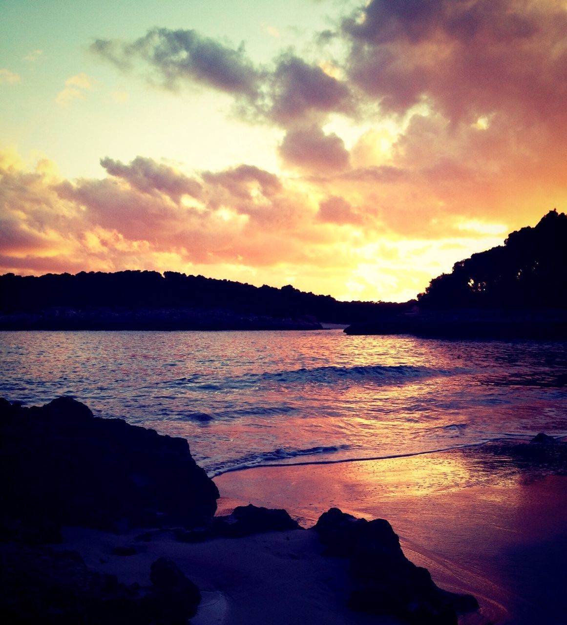 sunset, water, scenics, silhouette, sky, tranquil scene, beauty in nature, sea, tranquility, orange color, cloud - sky, idyllic, nature, reflection, rock - object, shore, beach, mountain, dusk, cloud