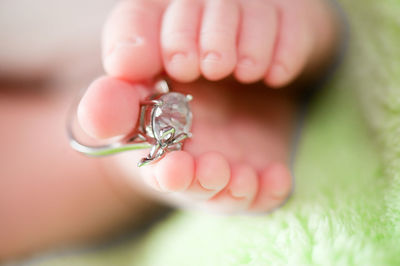 Close-up of ring on baby foot