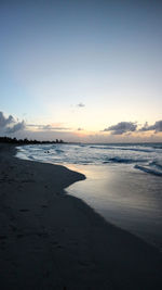Scenic view of beach against sky during sunset