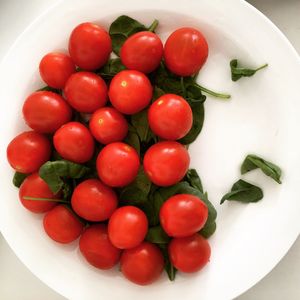 High angle view of cherry tomatoes in bowl on table