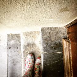 Low section of woman standing on tiled floor