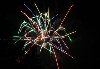 Low angle view of firework display at night