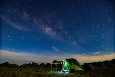 Tent on field against sky at night