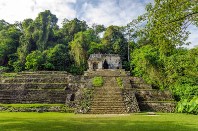 Exterior of historic temple against trees