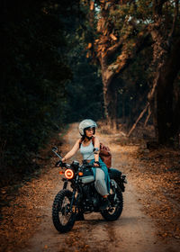 Woman riding motorcycle on road