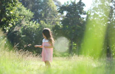 Full length of girl relaxing on grass