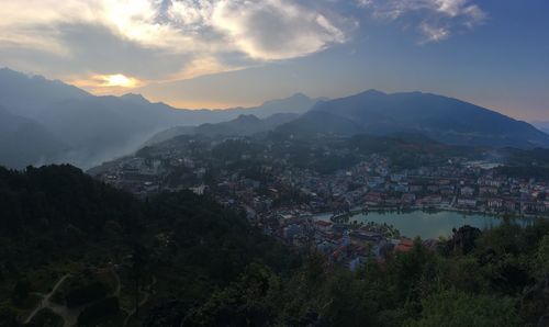 High angle view of townscape and mountains against sky