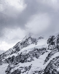 Scenic view of snow covered mountains against sky