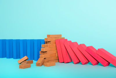 Close-up of colored pencils on table against blue background