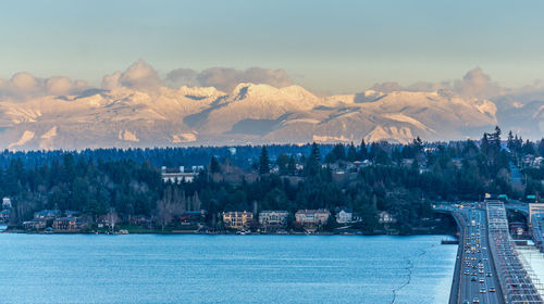 A view of the shoreline of bellevue, washington with mountains in the distance.