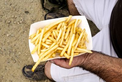 Low section of man holding food