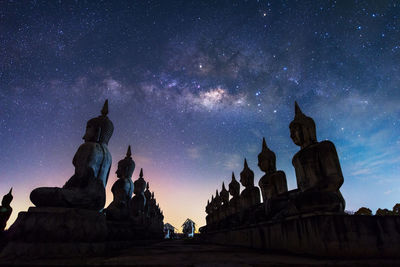 Statue of temple against sky at night