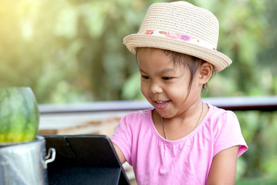 Smiling girl using digital tablet
