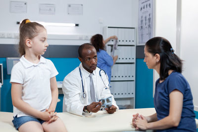 Doctor talking with woman at clinic