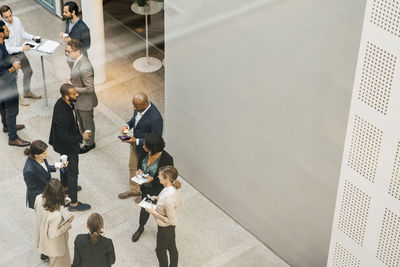 High angle view of male and female entrepreneurs talking outside office