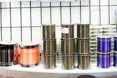 Close-up of containers in threads on table