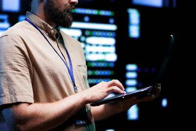 Midsection of man using mobile phone