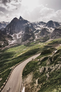 Scenic view of road by mountains against sky