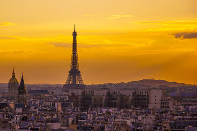 Buildings against cloudy sky during sunset