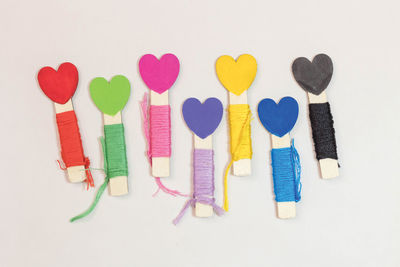 High angle view of multi colored pencils over white background