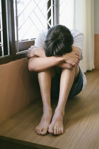 Woman sitting on floor at home