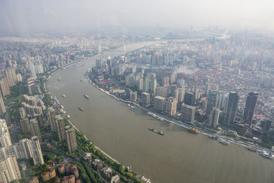 High angle view of river amidst buildings in city