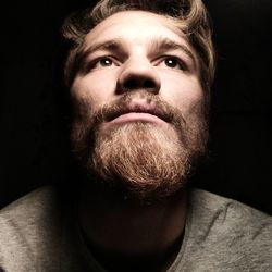 Portrait of man against black background