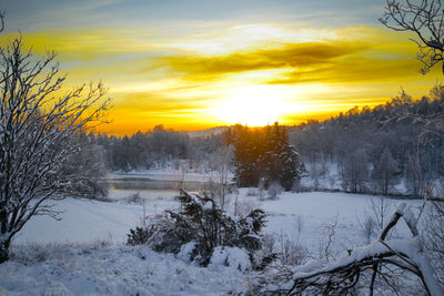 Scenic view of snow covered landscape during sunset