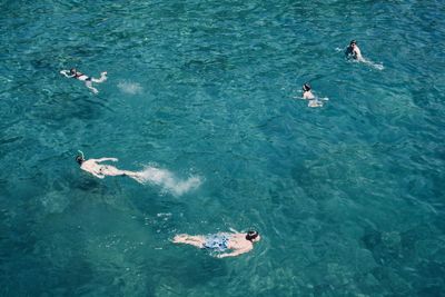 High angle view of people swimming in sea