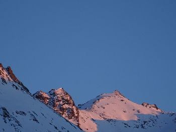 Scenic view of snowcapped mountains against clear blue sky