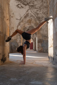 Full length of woman jumping in tunnel