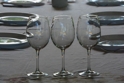 Close-up of wine glasses on table