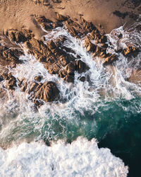Water flowing through rocks in sea