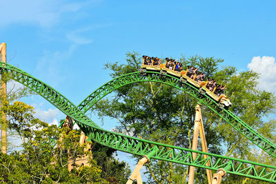 Low angle view of amusement park ride against sky