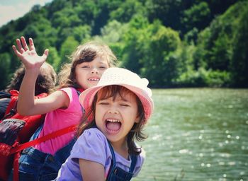 Cute sisters against lake