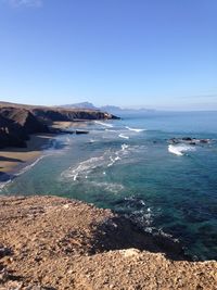 Scenic view of sea against clear blue sky