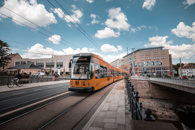 View of railroad tracks in city against sky