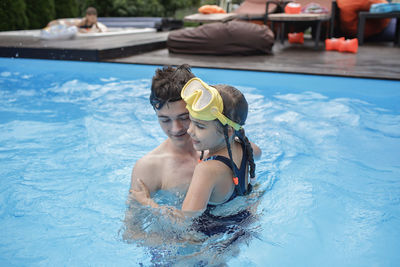 Portrait of shirtless boy swimming in pool