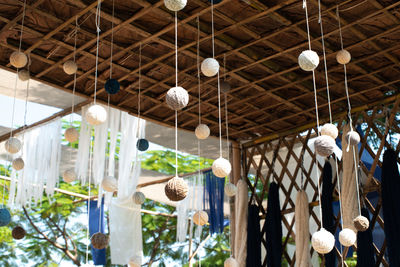 Low angle view of pendant light hanging on ceiling in building