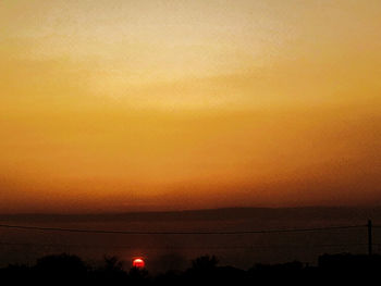 Scenic view of silhouette landscape against romantic sky at sunset