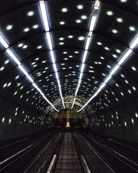 Illuminated tunnel at night