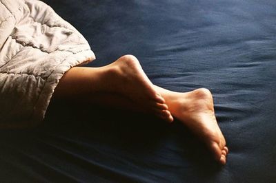 Low section of woman standing on tiled floor