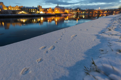 View of frozen river in city