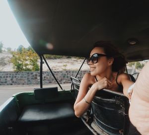 Young woman sitting in car