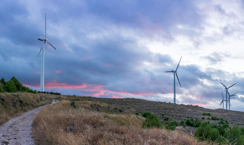 Windmill on field against sky