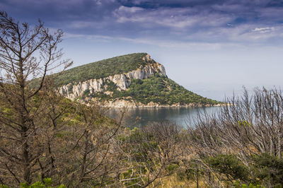 Scenic view of sea and mountains against sky